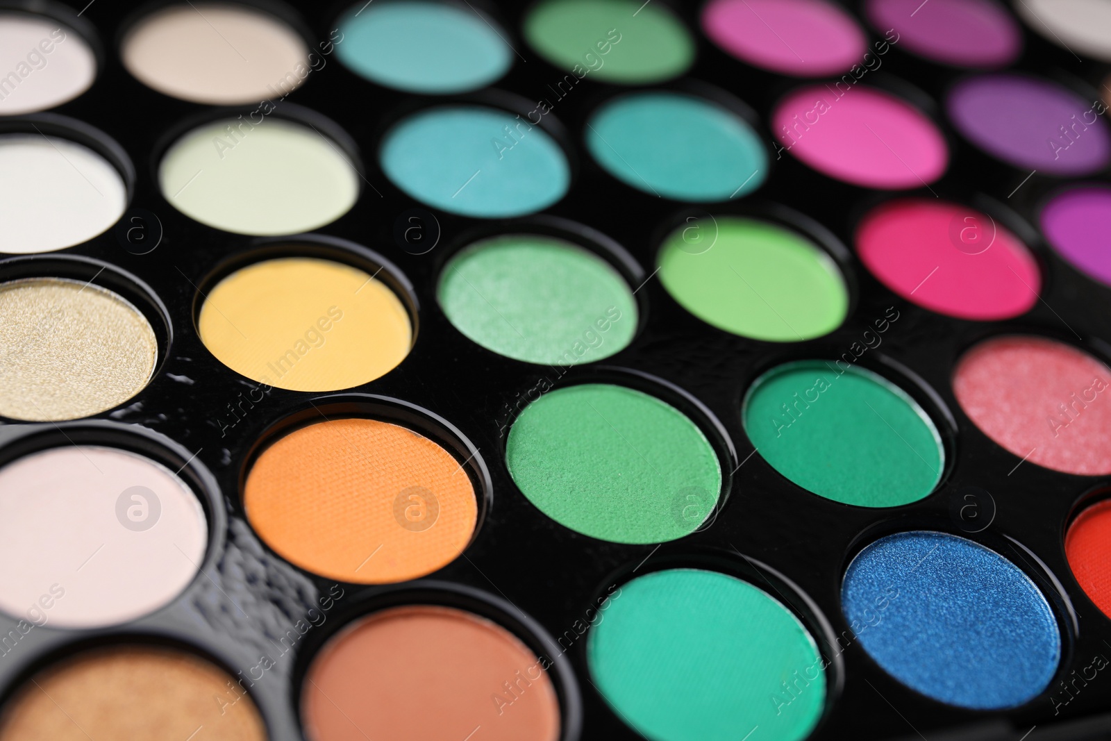 Photo of Beautiful eyeshadow palette as background, closeup. Professional cosmetic product