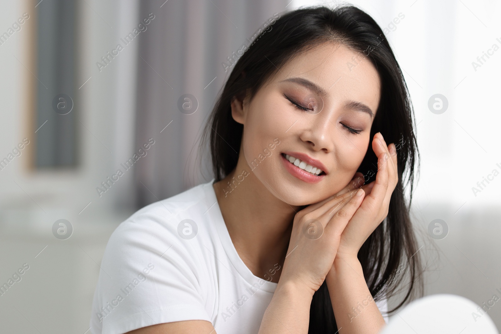 Photo of Portrait of beautiful woman with perfect skin at home