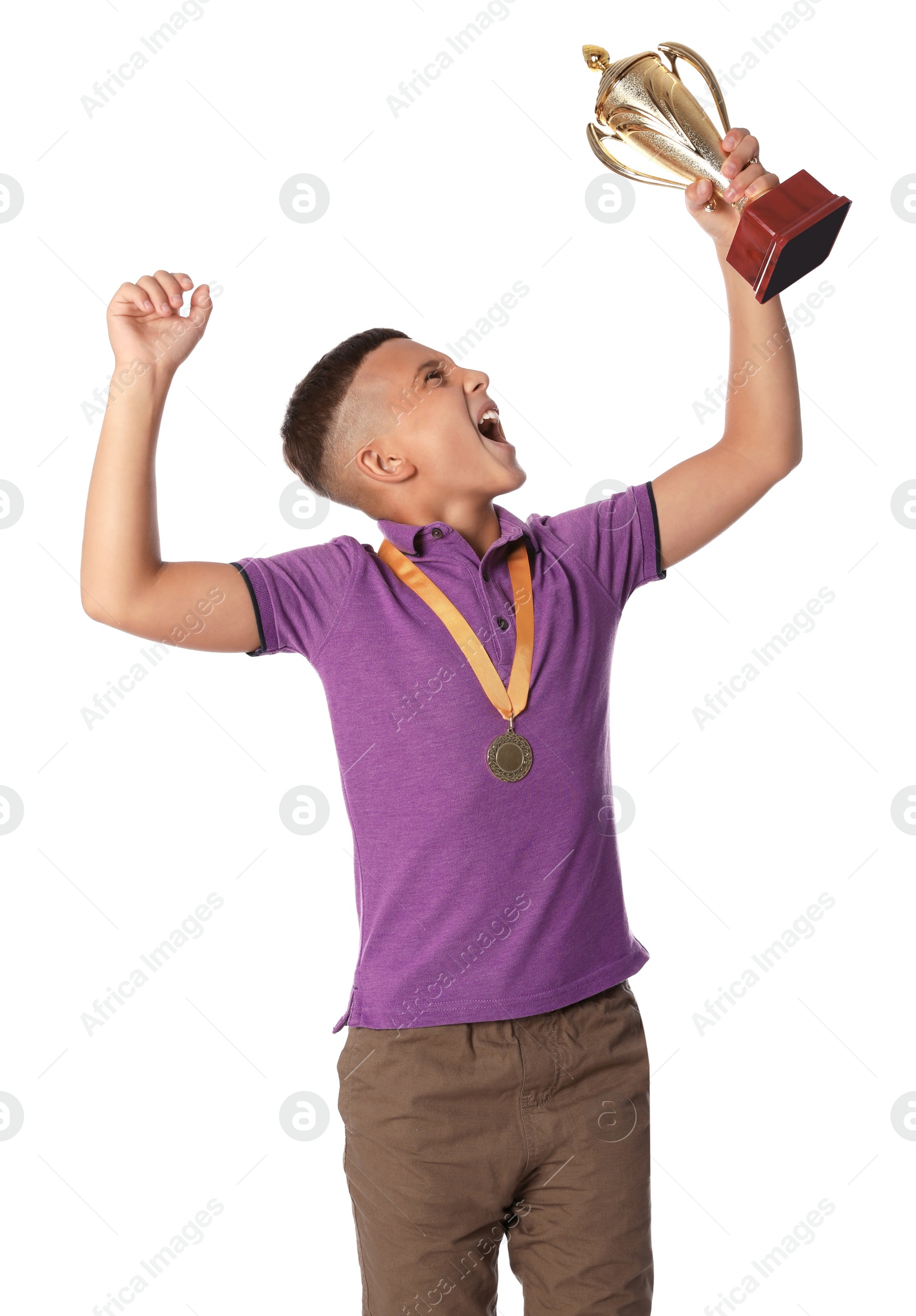 Photo of Happy boy with golden winning cup and medal on white background