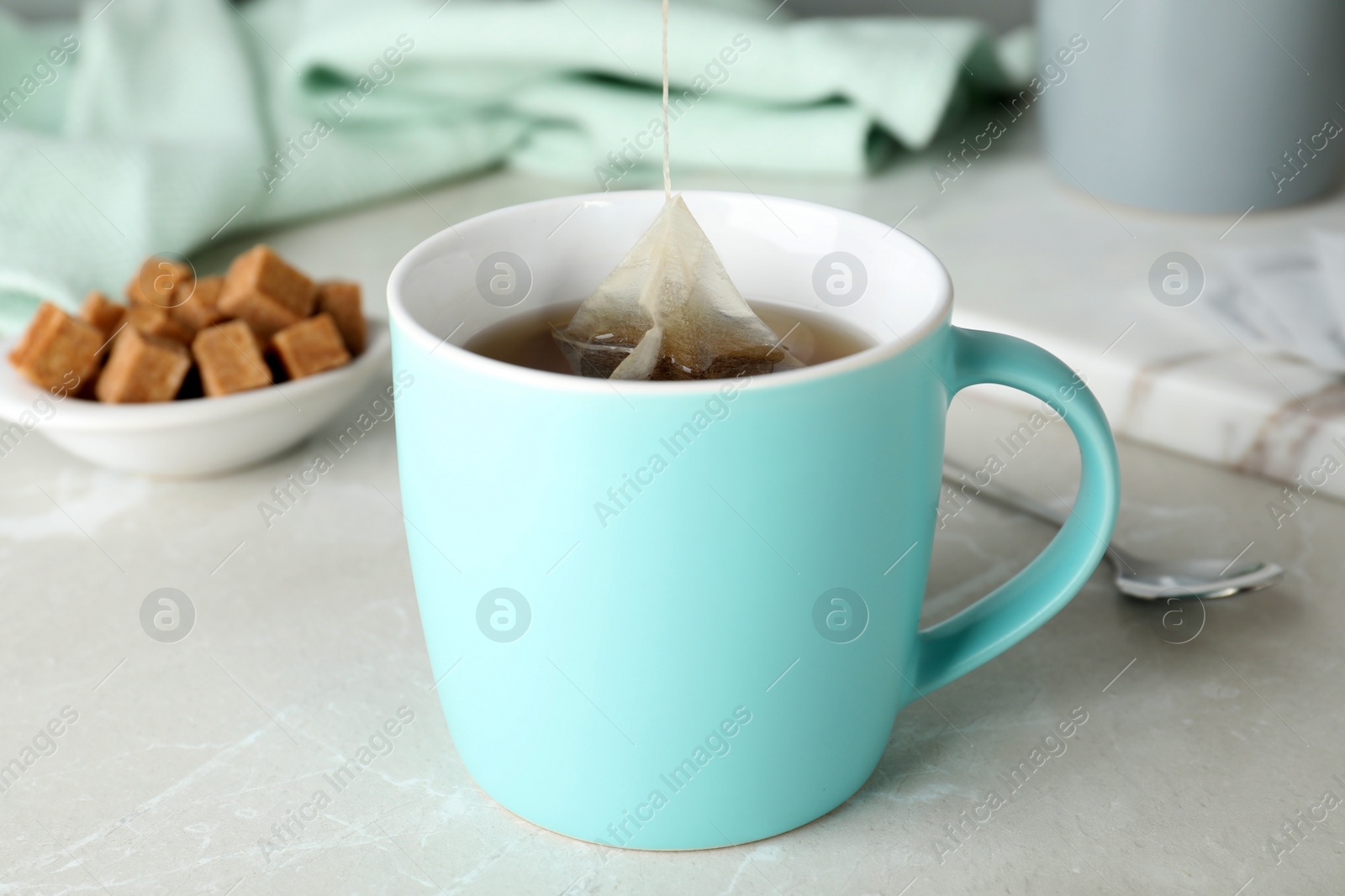 Photo of Cup of delicious hot tea on table