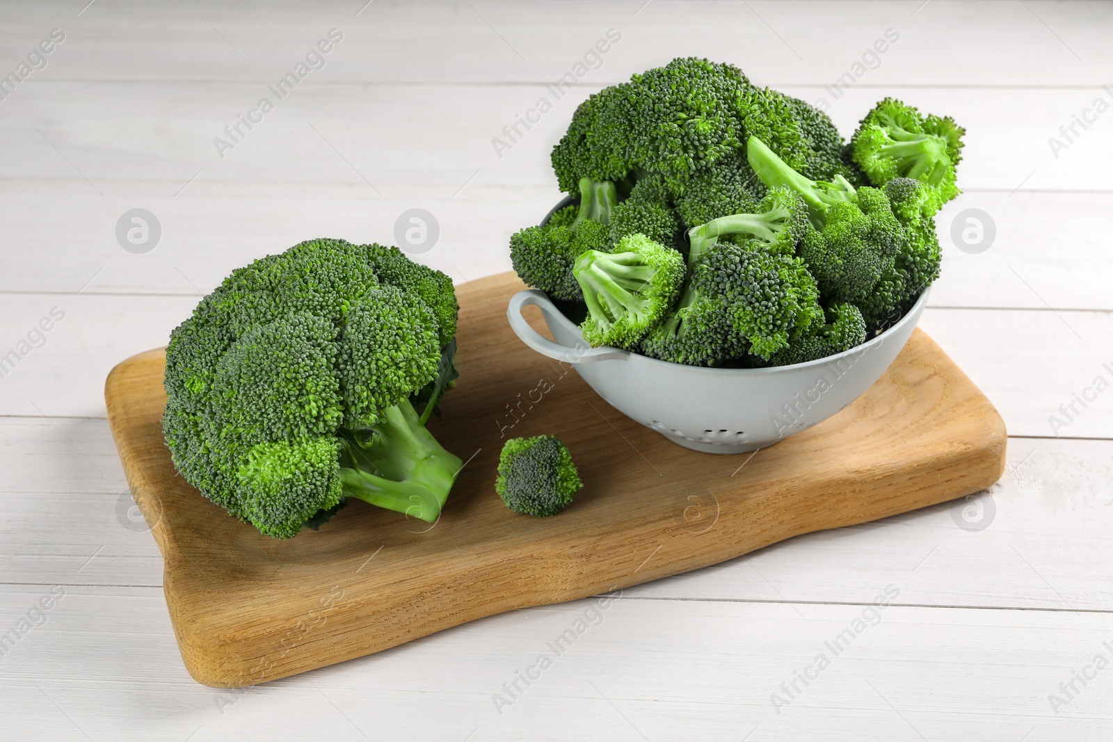 Photo of Fresh raw broccoli on white wooden table