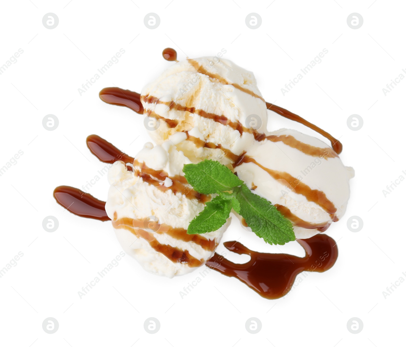 Photo of Scoops of ice cream with caramel sauce and mint isolated on white, top view