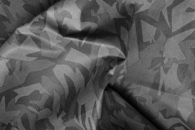 Image of Texture of crumpled camouflage fabric as background, top view. Black and white effect