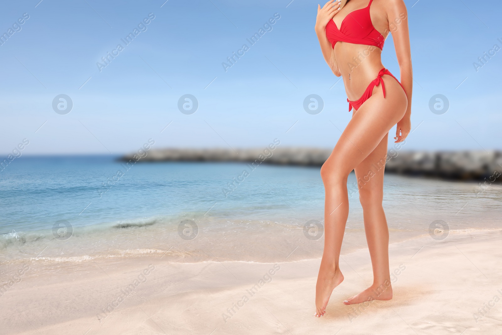 Image of Young woman with smooth silky skin after epilation on beach, closeup. Space for text