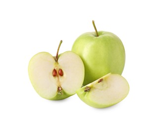 Photo of Whole and cut green apples isolated on white