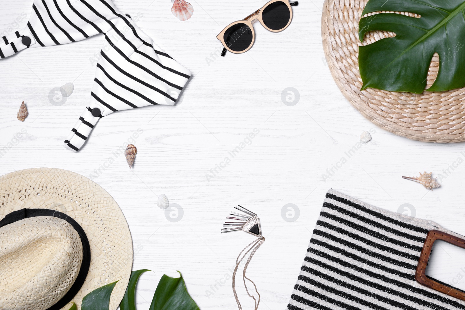 Photo of Flat lay composition with beach bag and accessories on white wooden background