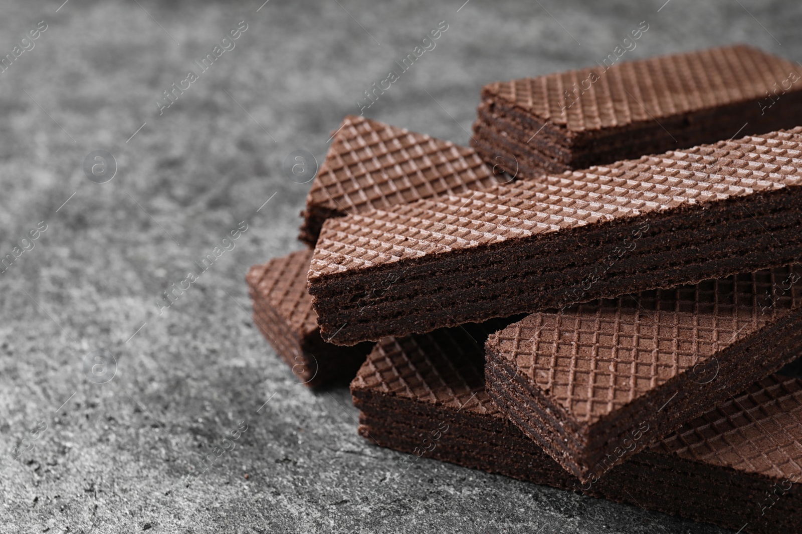 Photo of Delicious chocolate wafers on grey table, closeup