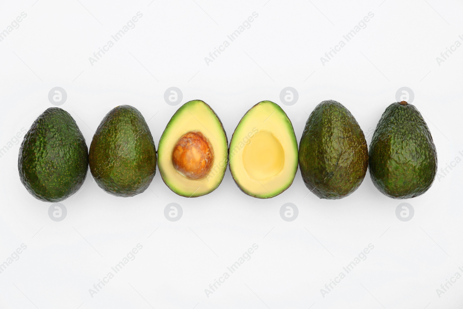 Photo of Tasty whole and cut avocados on white background, flat lay