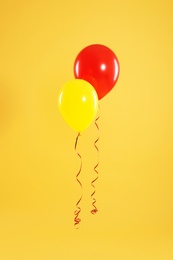 Photo of Bright balloons on color background. Celebration time