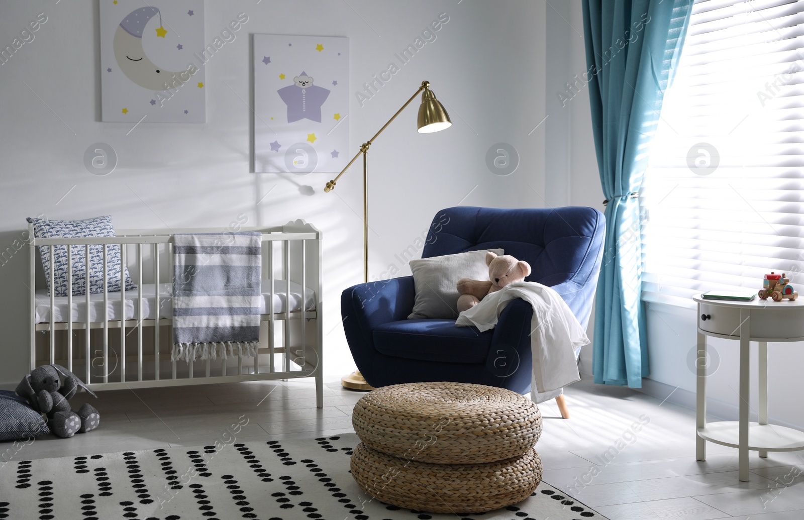 Photo of Cozy baby room interior with comfortable armchair