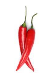 Photo of Ripe red hot chili peppers on white background, top view
