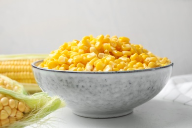 Photo of Bowl of preserved corn on white table