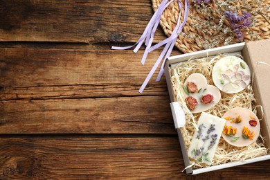 Photo of Flat lay composition with scented sachets on wooden table, space for text