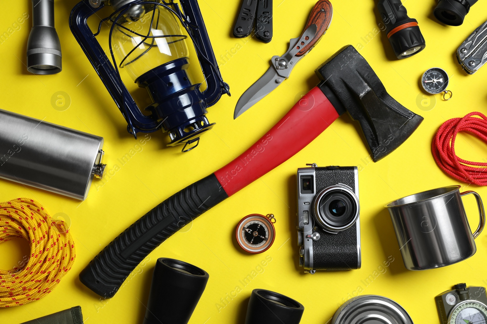 Photo of Set of traveler's equipment on yellow background, flat lay