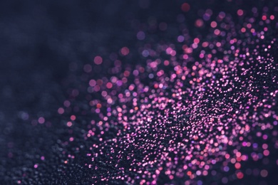 Photo of Pink glitter with bokeh effect on dark background