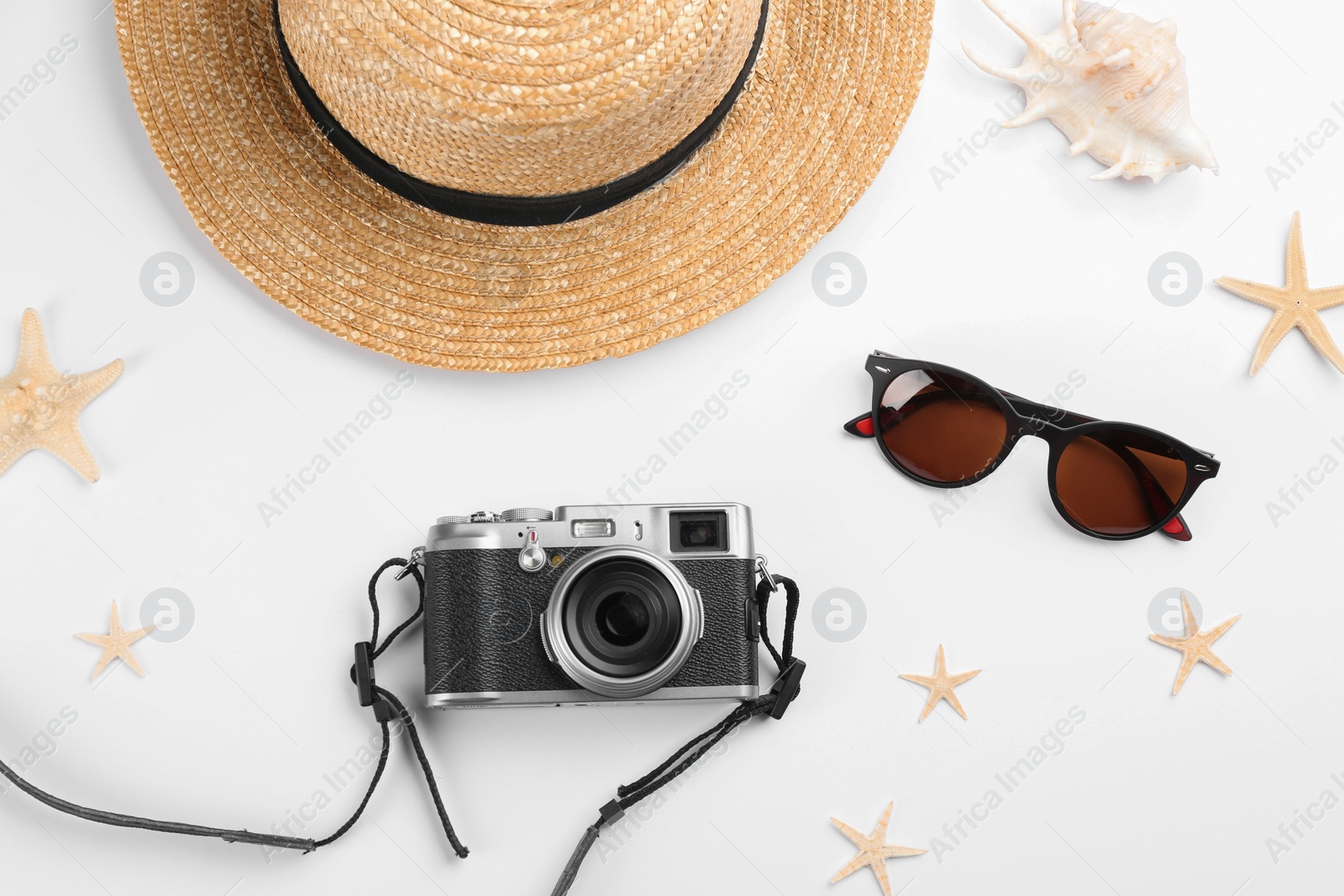 Photo of Composition with camera for professional photographer and beach objects on white background, top view