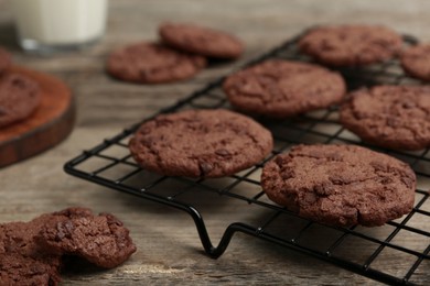 Photo of Delicious chocolate chip cookies on wooden table, closeup