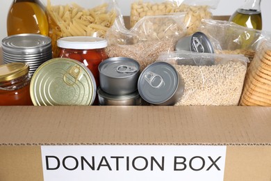 Photo of Donation box full of different food , closeup