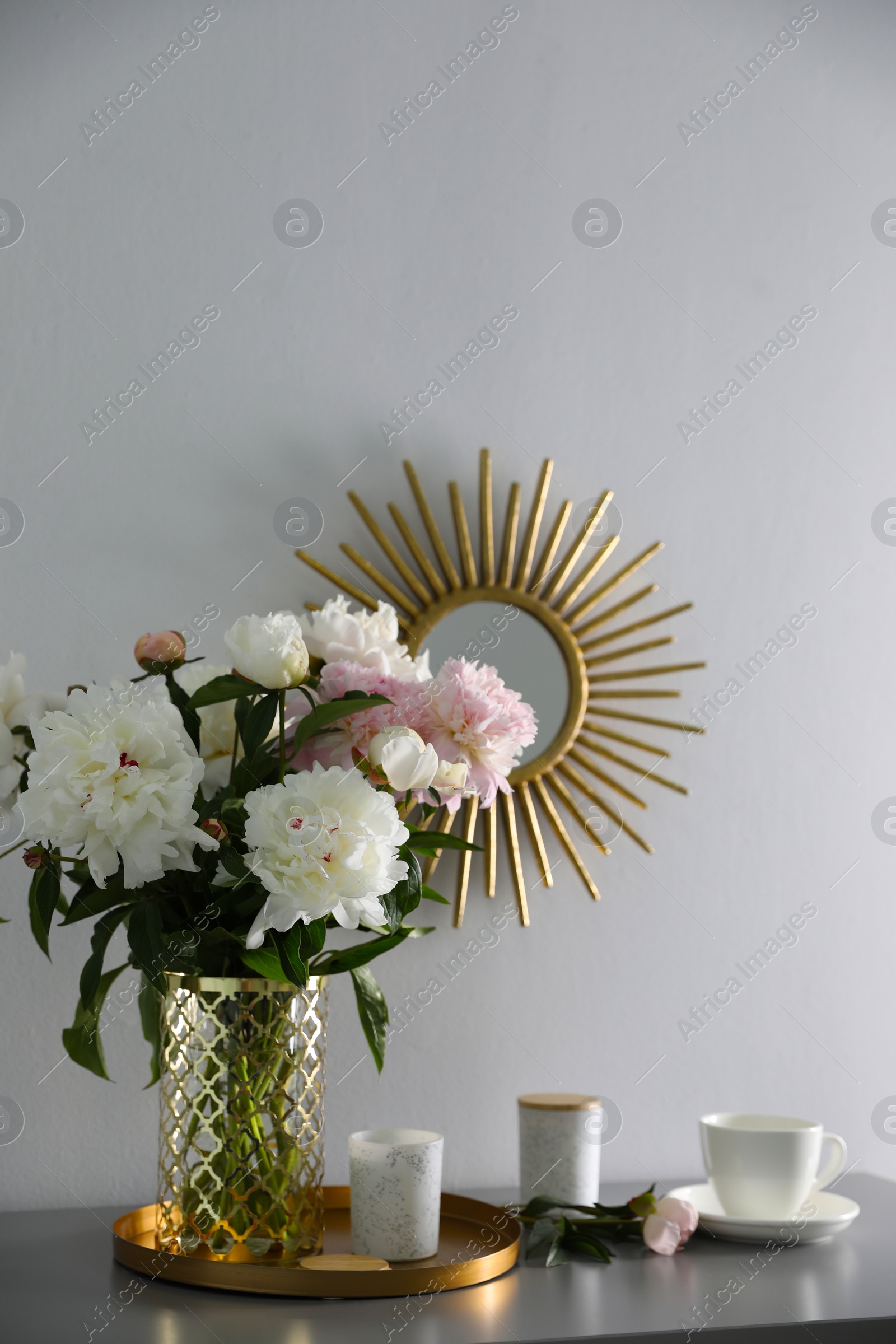 Photo of Bouquet of beautiful peony flowers on table indoors