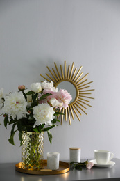 Photo of Bouquet of beautiful peony flowers on table indoors