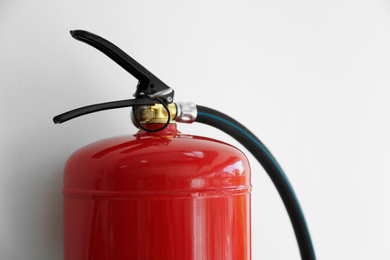 Photo of Fire extinguisher on white background, closeup view