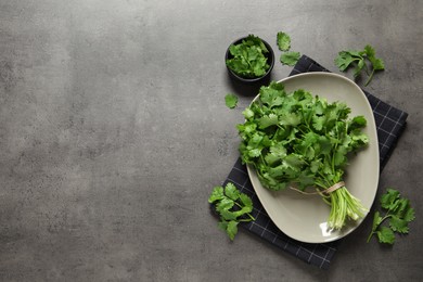 Photo of Fresh aromatic cilantro on grey table, flat lay. Space for text