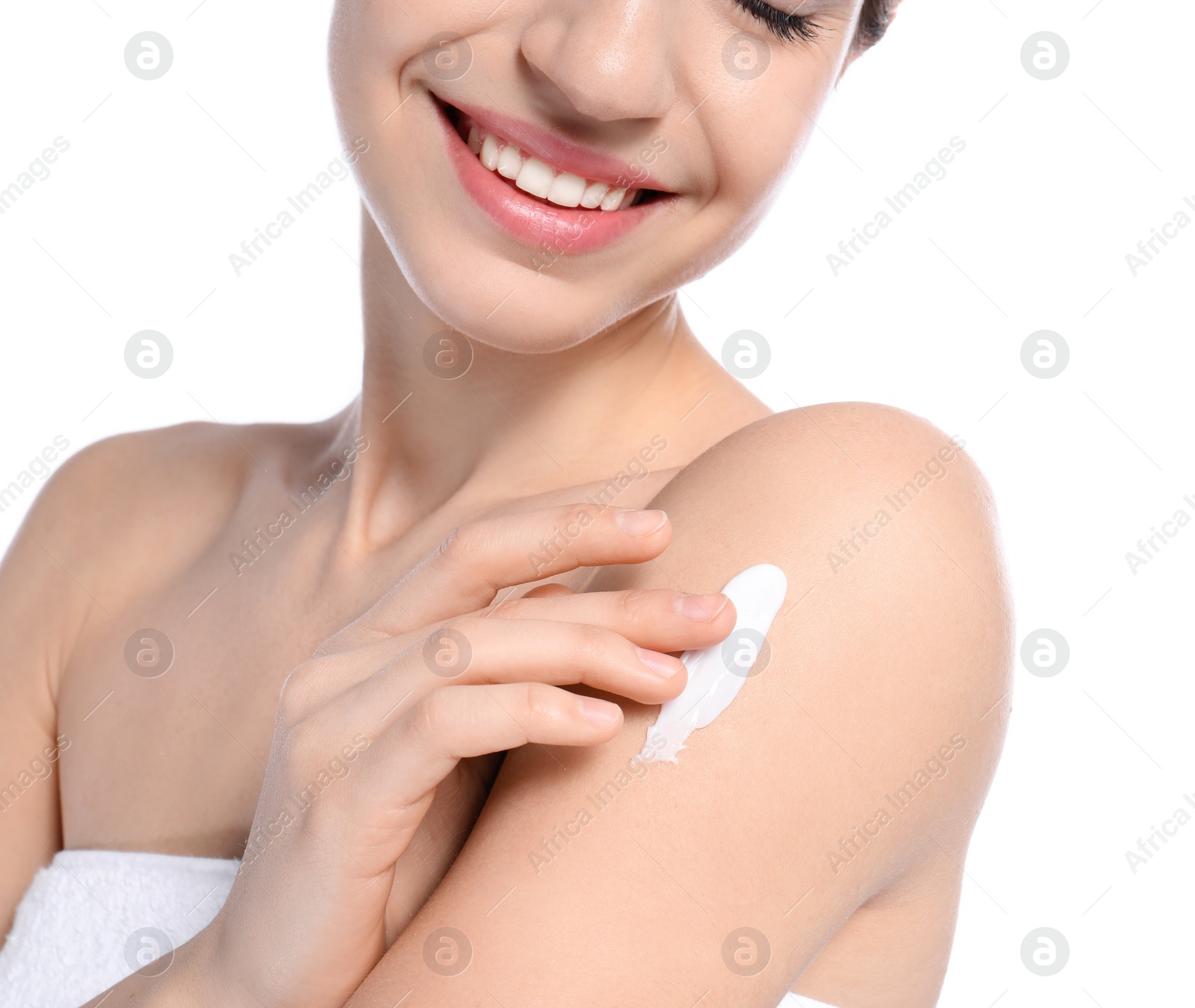 Photo of Young woman applying cream on white background, closeup. Beauty and body care