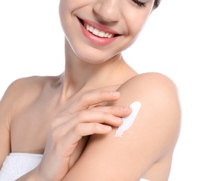 Photo of Young woman applying cream on white background, closeup. Beauty and body care