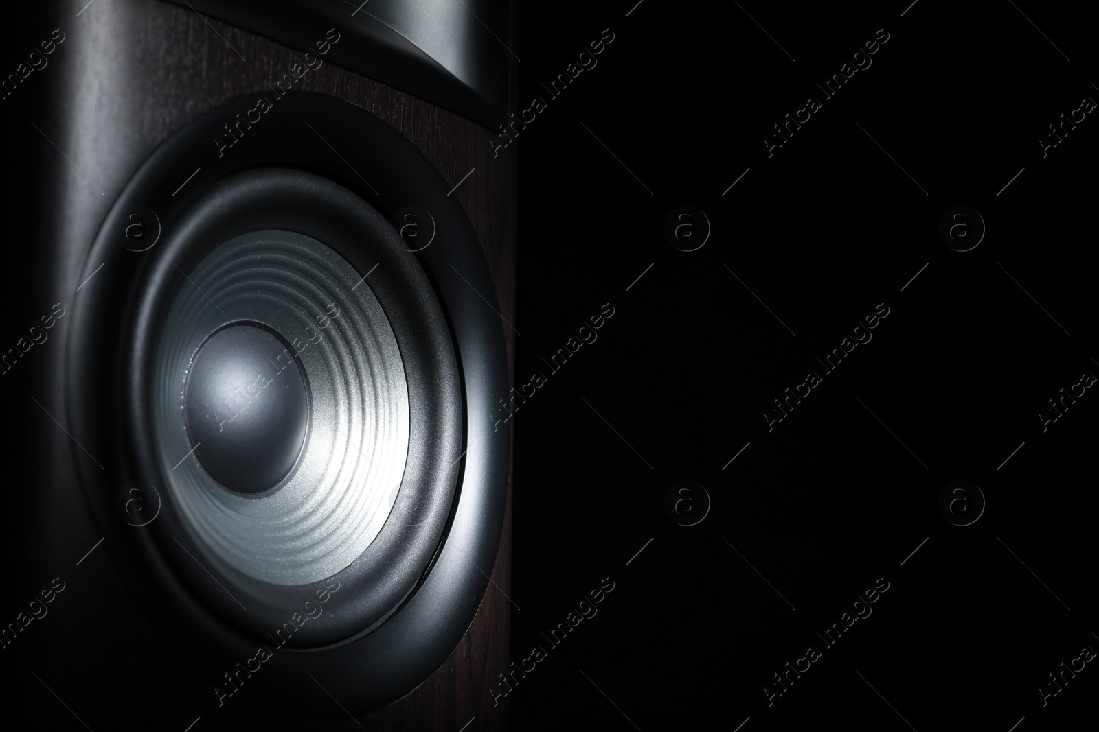 Photo of One sound speaker on black background, closeup. Space for text