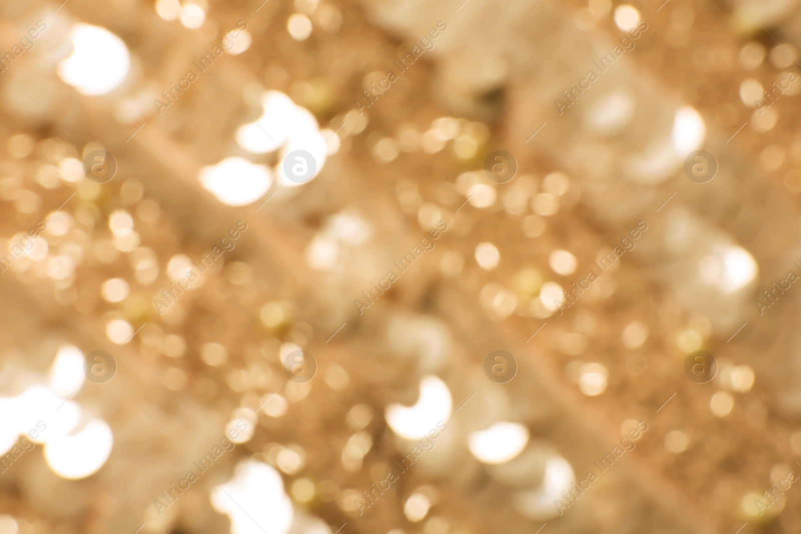 Photo of Blurred view of shiny golden surface as background