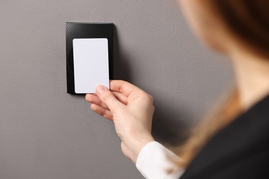 Photo of Woman unlocking door with key card, closeup