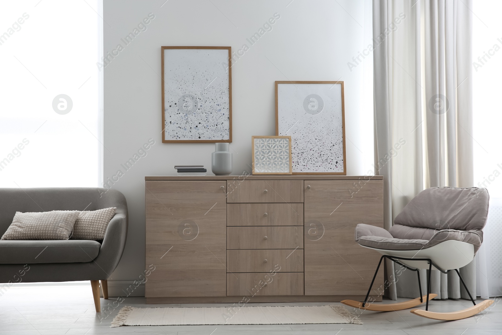 Photo of Modern room interior with stylish chest of drawers