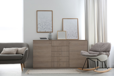 Photo of Modern room interior with stylish chest of drawers