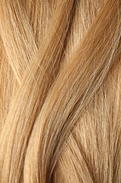 Photo of Texture of healthy blond hair as background, closeup