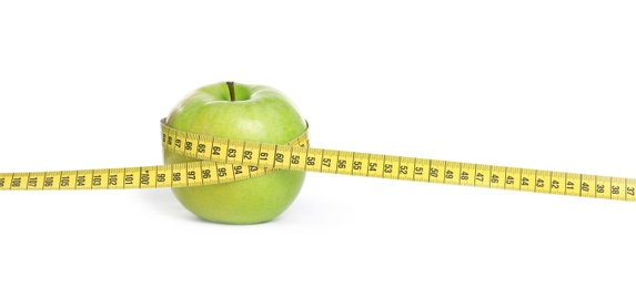 Photo of Apple and measuring tape on white background. Concept of weight loss