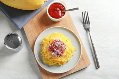 Flat lay composition with cooked spaghetti squash on white table