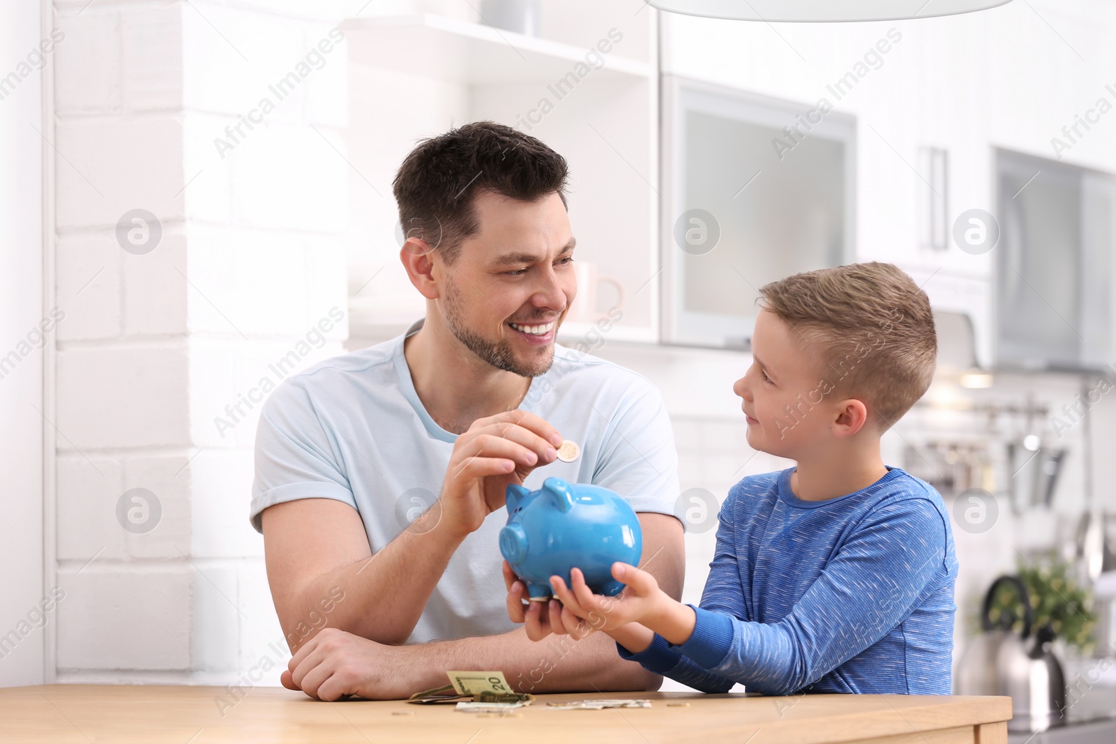 Photo of Family with piggy bank and money at home