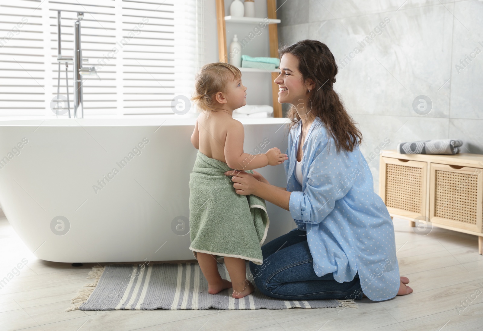 Photo of Mother with her daughter after bath at home