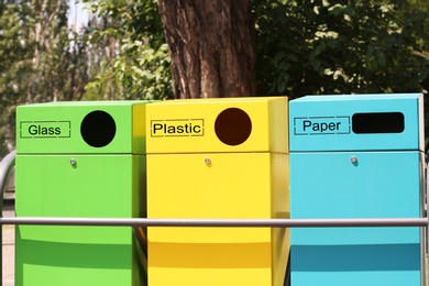 Photo of Waste sorting bins on city street. Recycling concept