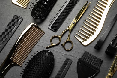 Photo of Hairdressing tools on grey textured background, flat lay