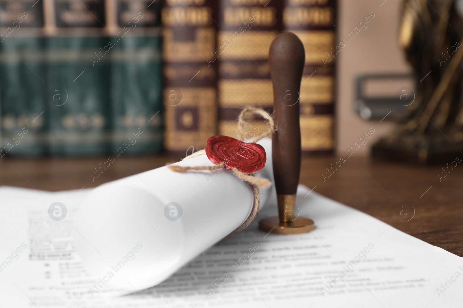 Photo of Documents and stamp on wooden table, closeup. Notary contract