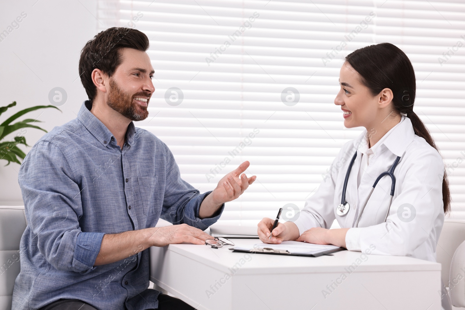 Photo of Doctor consulting patient during appointment in clinic