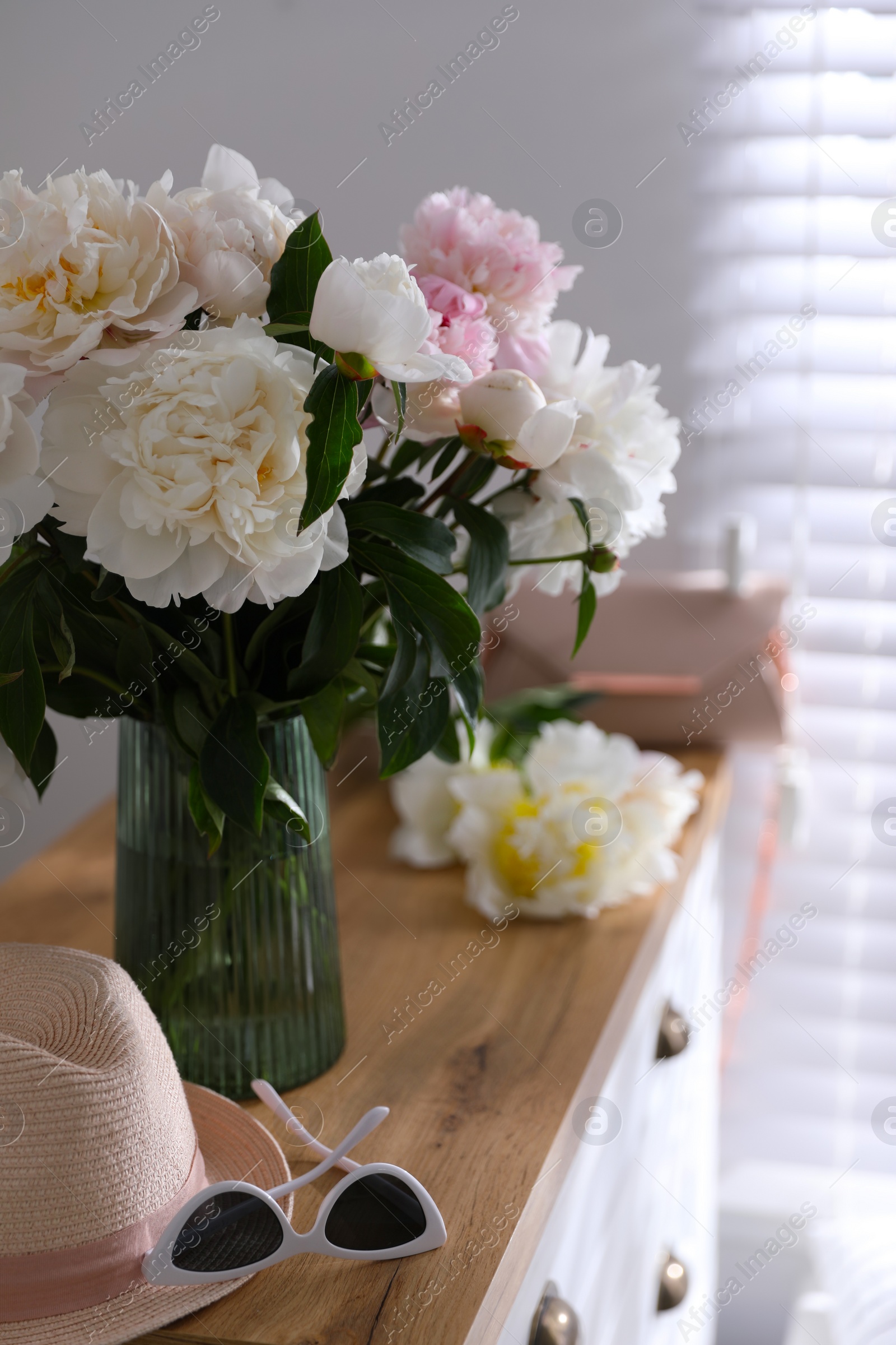 Photo of Bouquet of beautiful peony flowers in room