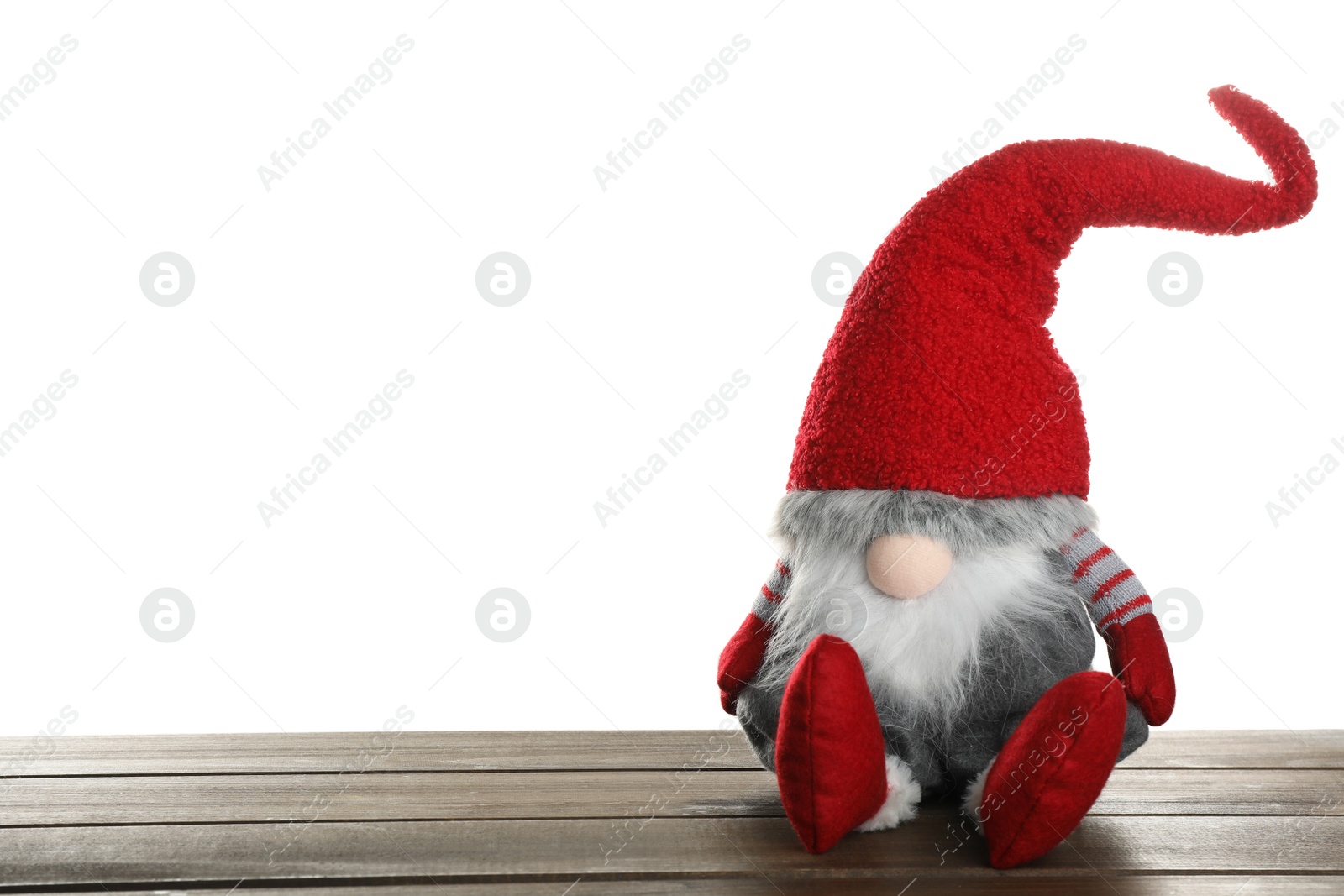 Photo of Funny Christmas gnome on wooden table against white background. Space for text