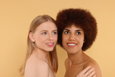 Portrait of beautiful young women on beige background