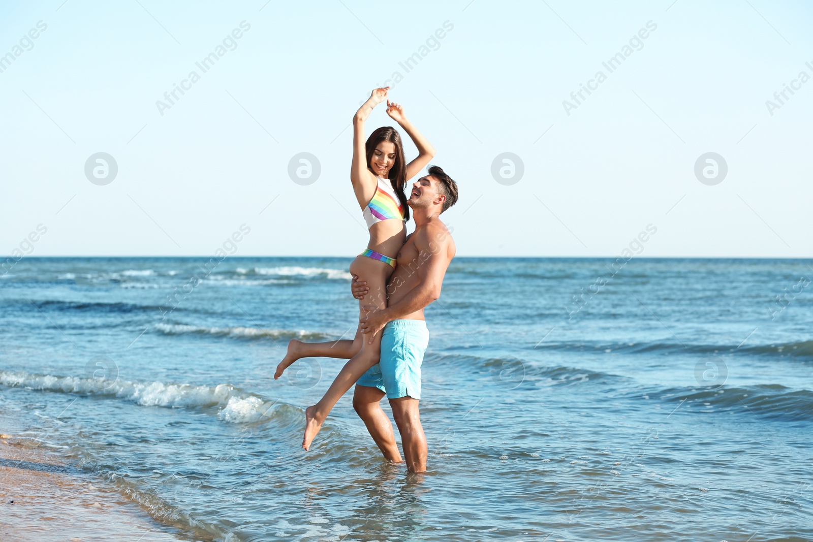 Photo of Happy young couple having fun at beach on sunny day