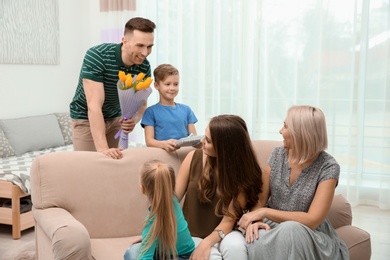 Little boy and his father congratulating their family at home