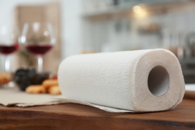 Photo of Roll of paper towels on table in kitchen, space for text