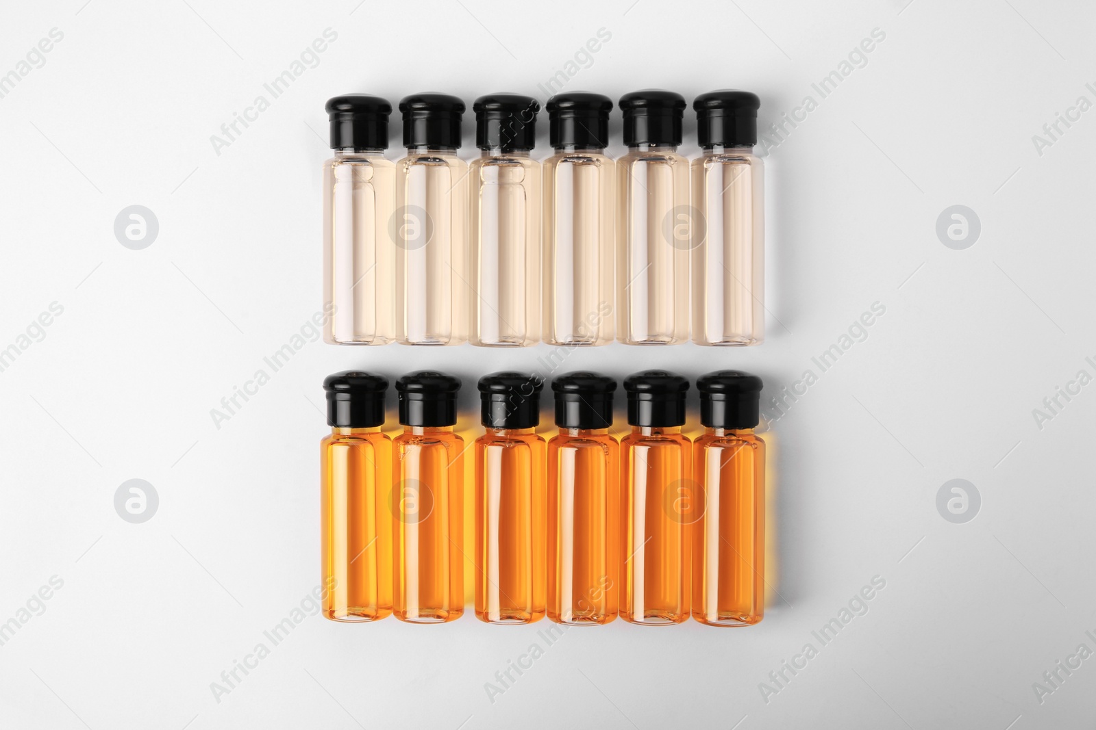 Photo of Bottles of cosmetic products on white background, flat lay