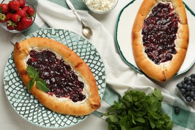 Photo of Delicious sweet cottage cheese pastry with cherry jam served on light table